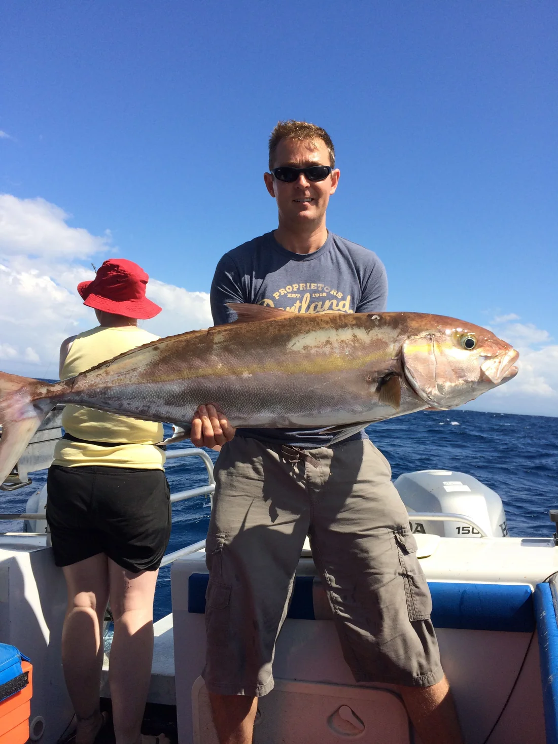 A guest with an amberjack caught aboard Windarra